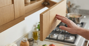 A modern kitchen cabinet with an upward-opening gas spring lift, providing clear access and ergonomic benefits.