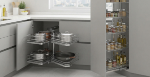 An integrated kitchen workstation featuring a black tempered glass built-in hob and a large stainless steel double-bowl sink set into a white quartz countertop.